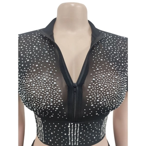 Detailed view of women's mesh top featuring sparkling silver rhinestones and front zipper