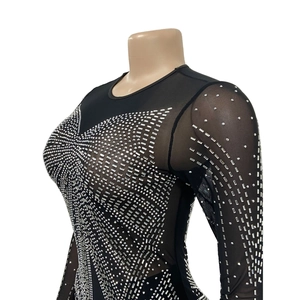 Detail of silver rhinestones on black mesh bodysuit with geometric sparkling patterns