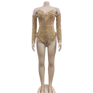 Detailed view of gold sequin bodysuit with deep V-neck and tan feather trim details