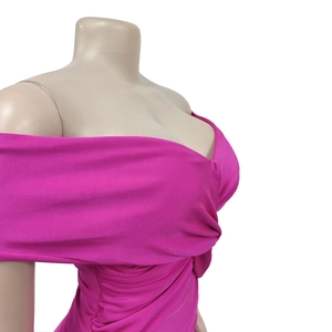 Detail of ruched twist knot design on a vibrant rose red off-shoulder slim-fit dress