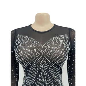 Close-up of sheer black mesh dress featuring intricate silver rhinestone patterns