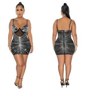 Close-up of mesh splicing and sparkling rhinestone stripes on a black bodycon dress