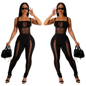 Detail of black two-piece set featuring sheer mesh panels and cut-out crop top design
