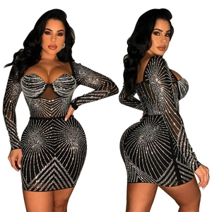 Close-up of black mesh mini dress with silver rhinestone starburst patterns and sweetheart neck