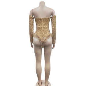 Detail view of gold sequin bodysuit featuring faux feather trim and back zipper closure