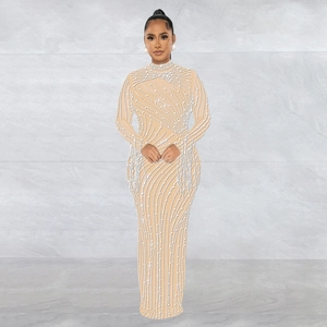 Close-up of sheer mesh long sleeve gown with elegant pearl detailing and rhinestones