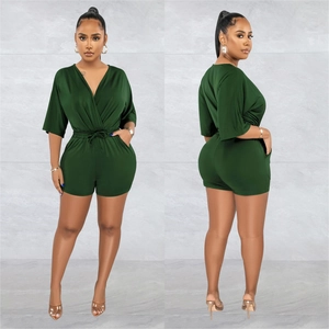 Detail of dark green V-neck romper with drawstring waist and side pockets