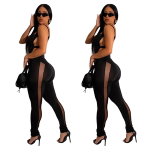 Women's chic black slim-fit jumpsuit with sheer mesh panels and cut-out strap details