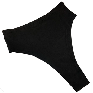 Detail view of black high-waisted ribbed knit panties with seamless edges on white backdrop