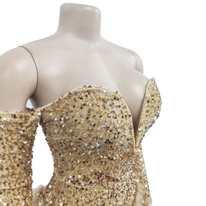 Close-up of golden sequins on a deep V-neck dress with elegant puff sleeves