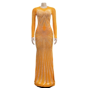 Detailed view of bright orange mesh dress featuring intricate rhinestone patterns and sleek fit