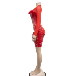 Detailed view of red mini dress with faux fur neckline and sparkling sequin embellishments