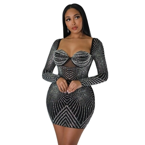 Close-up of a black bodycon mini dress with silver rhinestones and mesh patchwork
