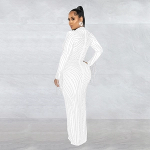 Detail of white mesh dress with silver rhinestones and elegant fringe on the sleeves