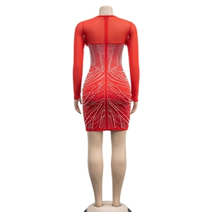 Detail view of the red bodycon dress back with mesh sleeves and symmetric rhinestone patterns