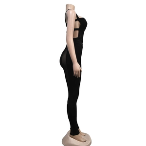 Detail view of black bodysuit featuring side cut-out and sheer mesh patchwork panels