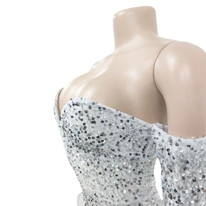 Detail of white off-shoulder romper featuring all-over silver sequin embellishments