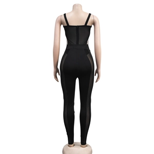 Detailed back view of black slim-fit jumpsuit with sheer mesh panels and hidden zipper