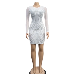 Detail of white mesh dress with sequin beadwork and feather trim on the neckline