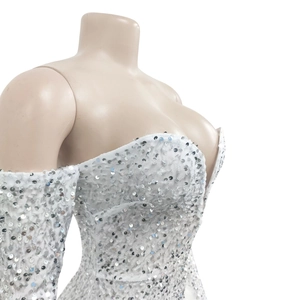 Detailed close-up of white sequin cocktail dress with sweetheart neckline and off-shoulder style