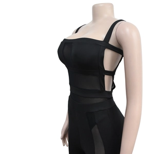 Detail view of black mesh patchwork bodysuit with side cutout and lace-up straps