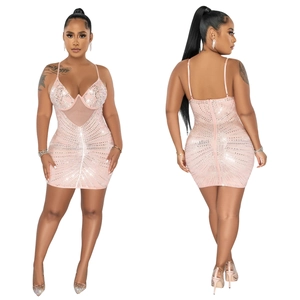 Detail of pink sequin mini dress featuring sheer mesh panels and sparkling V-neckline