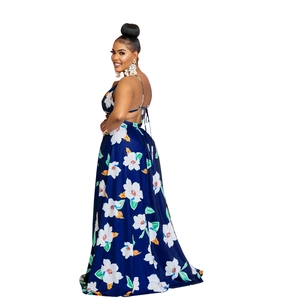 Detail view of the open-back halter design and white floral print on a navy maxi dress