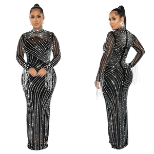 Detail of elegant black mesh evening dress with silver rhinestones and long fringes