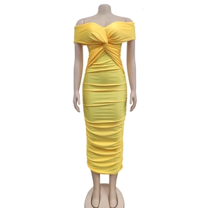 Detail view of the yellow ruched fabric and knot decoration on the strapless dress