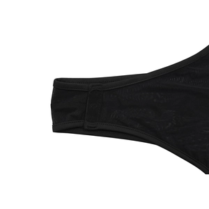 Close-up of fine black mesh fabric with reinforced stitching on a women's outfit
