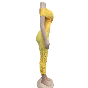 Side view of ginger yellow ruched off-shoulder maxi dress with slim fit elastic fabric