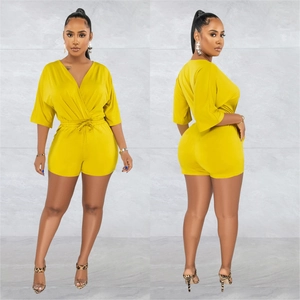 Detailed front and back views of a mustard yellow v-neck tie-waist romper for women
