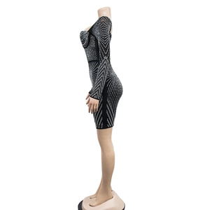 Detail of black bodycon dress with silver rhinestone geometric patterns and long sleeves