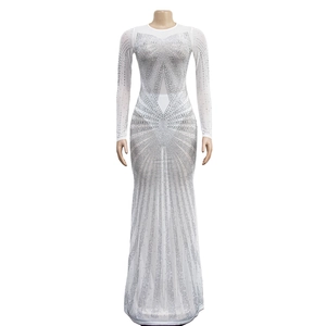 Close-up of white mesh evening gown featuring intricate silver rhinestone patterns