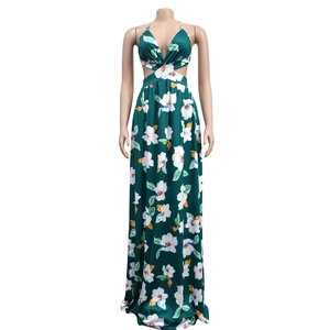 Detail of cross-front knot and side cut-outs on a floral halter maxi dress