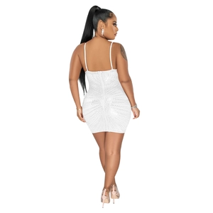 Detail of white mesh bodycon mini dress featuring intricate rhinestone patterns and back zipper
