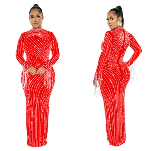 Detail of red mesh rhinestone dress showing elegant fringe tassels on the long sleeves
