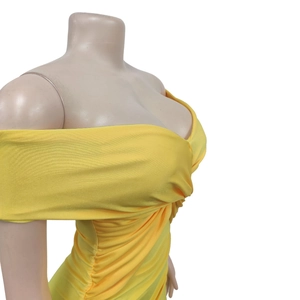 Detail of yellow off-shoulder dress featuring ruched fabric and crossover knot design
