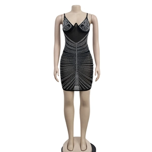 Close-up of sparkling rhinestones in radial patterns on a black sleeveless bodycon dress