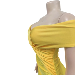 Detailed view of the bright yellow ruched cross neckline on this strapless maxi dress