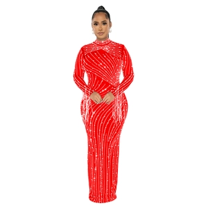 Detail of red mesh dress with hot-fix rhinestones and fringe tassels on long sleeves