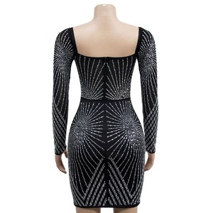 Detail of square neck mesh dress with geometric silver rhinestones on black fabric