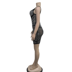 Detail of black bodycon mesh dress featuring rhinestone wavy geometric lines and straps