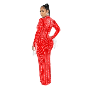 Detail of red rhinestone gown with white fringe sleeves and elegant beaded patterns
