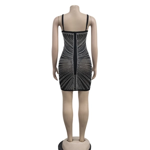 Detailed back view of a black mini dress with geometric rhinestones and hidden zipper