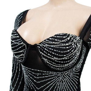 Close-up of sparkling silver rhinestones on a black mesh dress with sweetheart neckline