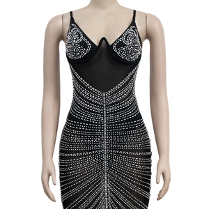 Detail of black mesh mini dress with silver rhinestones and deep V-neckline on mannequin
