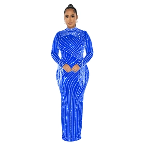 Detail of blue evening gown featuring silver rhinestones and fringed sleeves