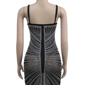 Detail view of back zipper and silver rhinestone geometric patterns on black mesh dress