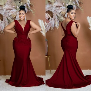 Detail of burgundy V-neck sleeveless fishtail dress with elegant pleated waist design